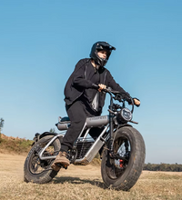 Rider on EcoBike Pro Max 2000W fat tyre electric bike riding off-road on open terrain wearing motocross helmet — powerful fat tyre e-bike for adventure riding Australia